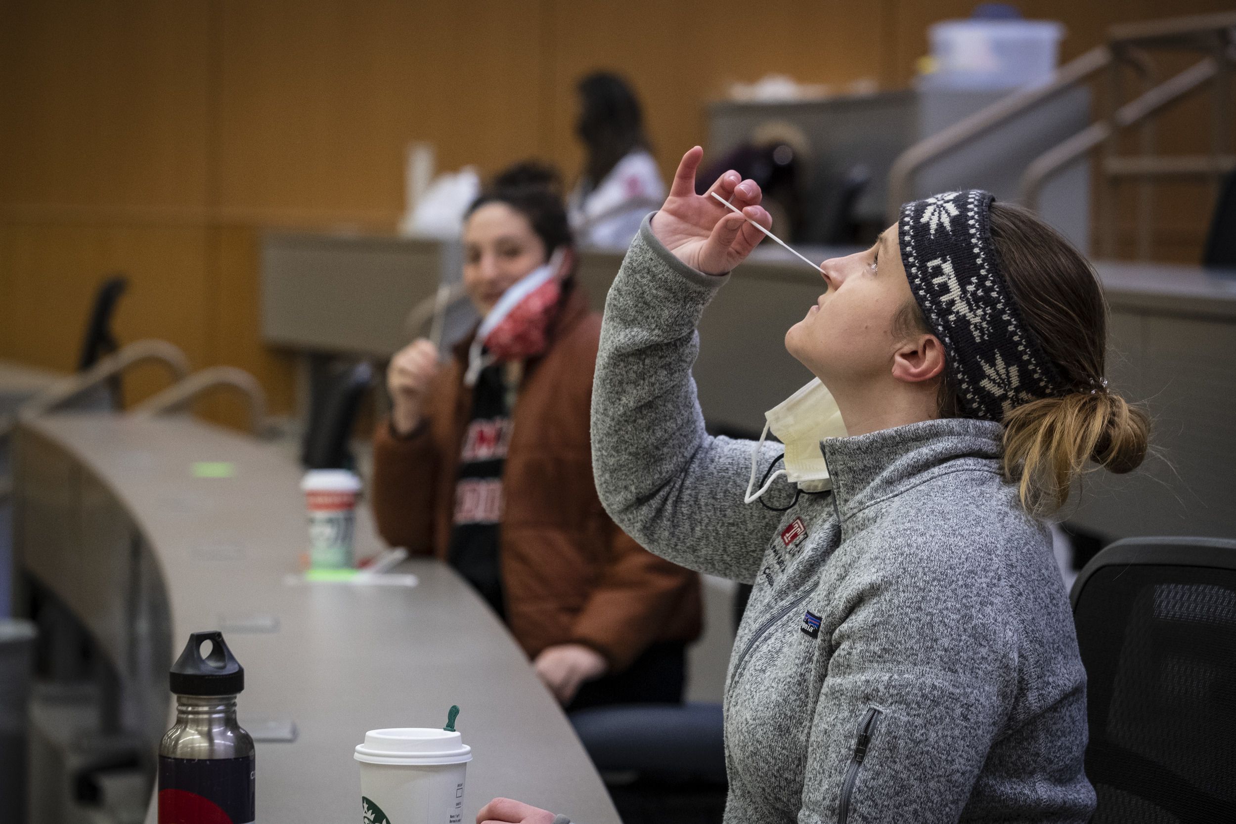 A Temple student self-administers a COVID-19 test.