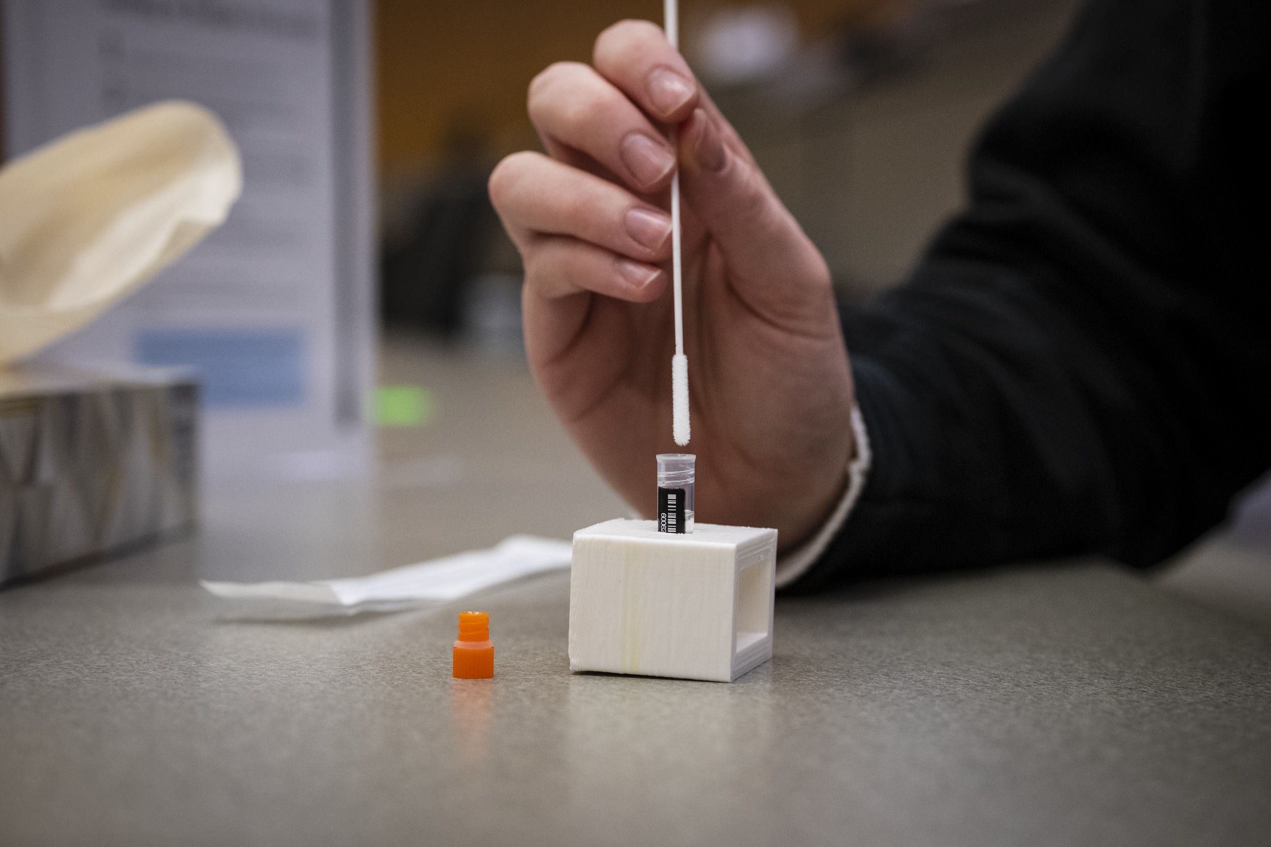 A COVID-19 testing swab and vial.
