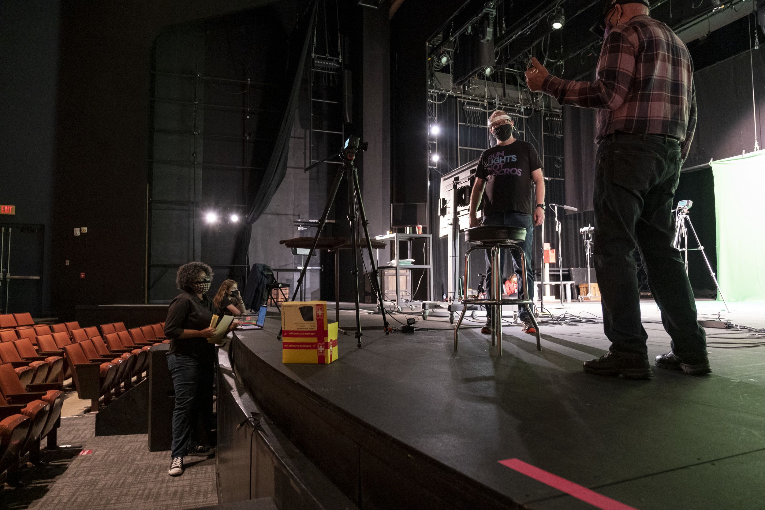 The crew members are taking directions from the director.