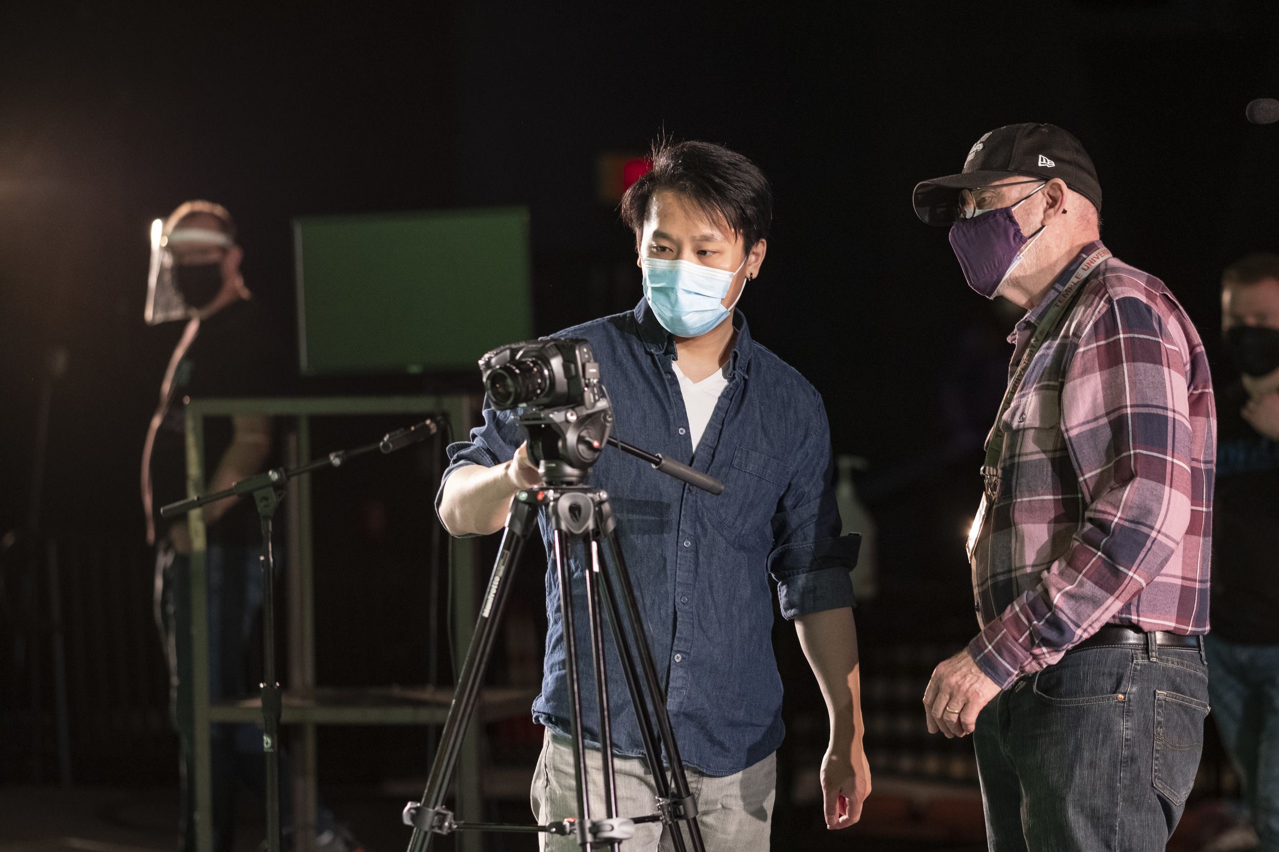 Director Doug Wager, and director of photography, behind a camera.